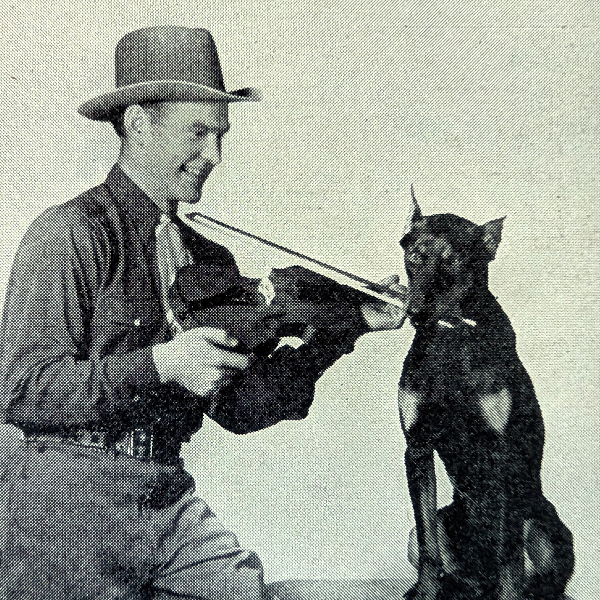 Arkansas Arkie helping a dog play the fiddle