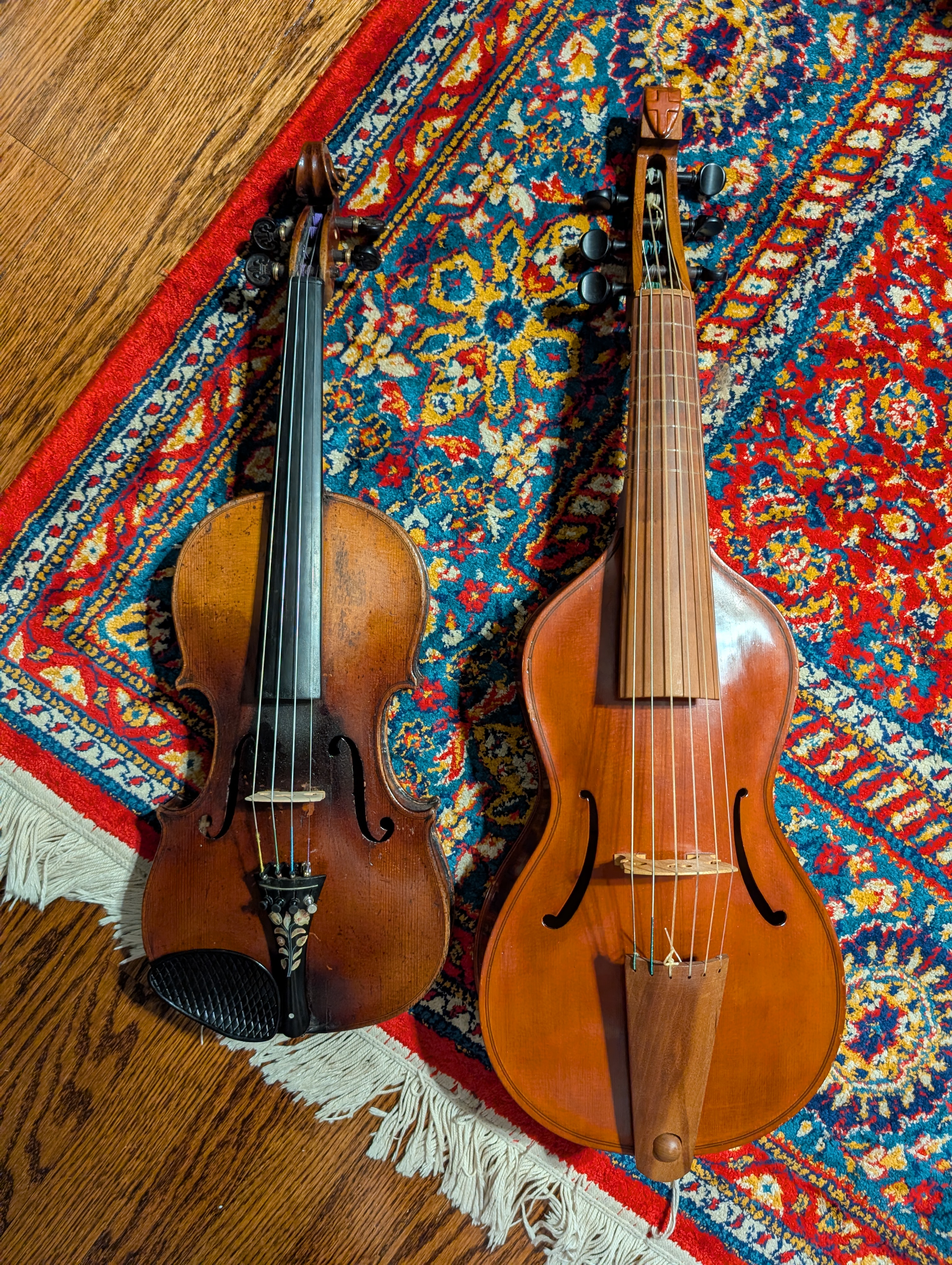 A violin on the left and a treble viol on the right, nearly the same size.